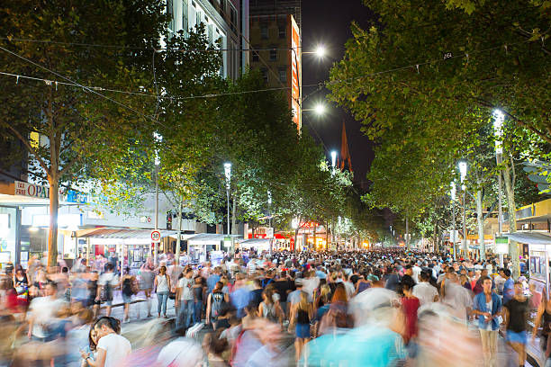 White Night Melbourne 2015 Melbourne, Australia - February 21, 2015 - Melbourne's famous Swanston St with large crowd at White Night celebration. arts centre melbourne stock pictures, royalty-free photos & images