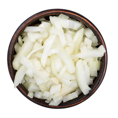 White onion chopped in a clay bowl. Vegetables, ingredients and staple foods. Isolated macro food photo close top on white background. File contains clipping path.