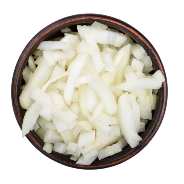 White onion chopped in a clay bowl. Vegetables, ingredients and staple foods. Isolated macro food photo close top on white background. stock photo