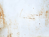 istock White painted metal texture with with rusty scratches. Rusty metal background. 1330098444