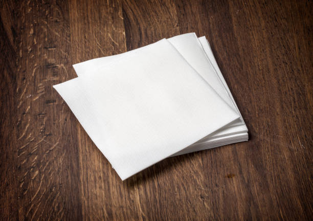 white paper napkin on  table white paper napkin on old wooden table napkin stock pictures, royalty-free photos & images