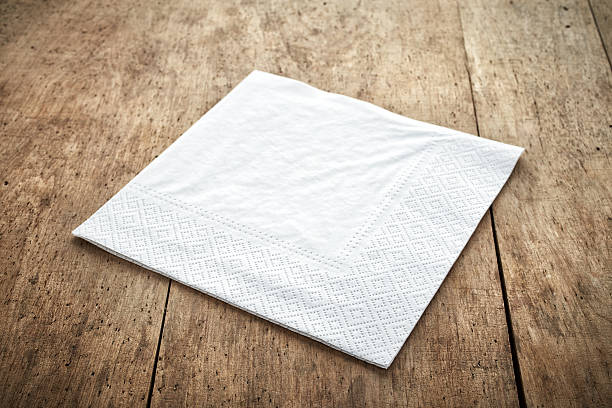 white paper napkin white paper napkin on old wooden table napkin stock pictures, royalty-free photos & images