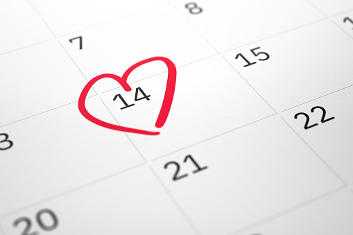 White paper planner calendar with red heart shape mark on 14 February. Happy Valentine's day concept. 3D illustration