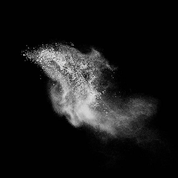 White powder explosion isolated on black stock photo