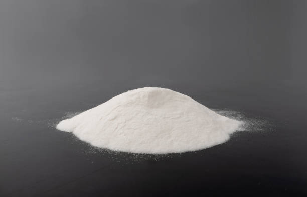 White Powder of Baking Soda, Clay or Bentonite Texture Heap of White Powder of Baking Soda, Clay or Bentonite on Black Background. Powdered Chemicals as Calcium, Gypsum or Plaster Side View glucosamine stock pictures, royalty-free photos & images