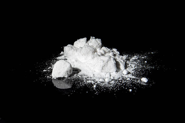 White powder on black reflective surface White powder on black reflective surface amphetamine stock pictures, royalty-free photos & images