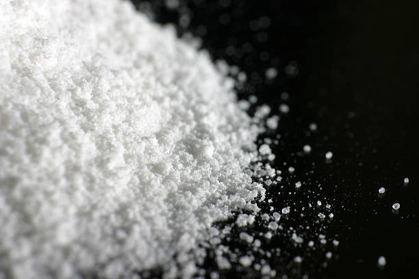 White powder A heap of white powder on black floor.  heroin stock pictures, royalty-free photos & images