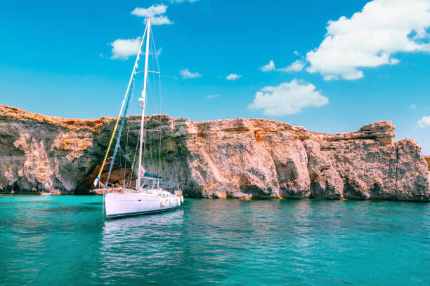 White sailing yacht in The Blue lagoon of Comino island, Malta. stock photo