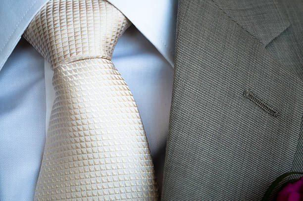 White silk tie with grey jacket lapel stock photo