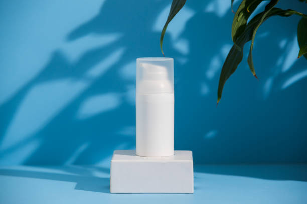 White skincare product tube on a blue background, advertisement concept. stock photo