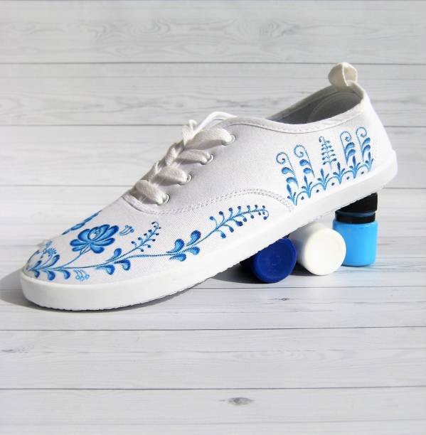 White sneakers hand painted with blue fiowers stock photo