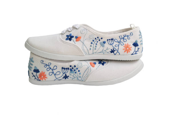 white sneakers with hand embroidery stock photo