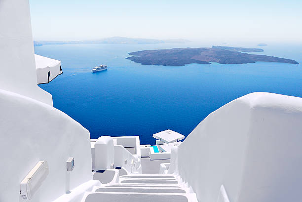 White staircases and Mediterranean sea view on Santorini, Greece White wash staircases on Santorini Island, Greece. The view toward Caldera sea with cruise ship awaiting. mediterranean culture stock pictures, royalty-free photos & images