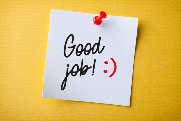 White Sticky Note With Good Job And Red Push Pin On Yellow Background stock photo