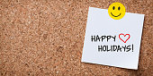 istock White Sticky Note With Happy Holidays And Red Push Pin On Cork Board 1393421502