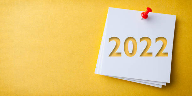 White Sticky Note With Happy New Year 2020 And Red Push Pin On Yellow Background stock photo