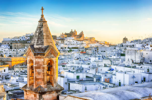 white town Ostuni and cathedral at sunrise stock photo