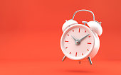 istock White vintage alarm clock on bright red background. Modern design, 3d rendering. 1340583418