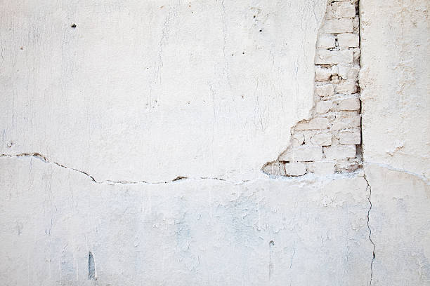 White wall with cracks and white brick stock photo