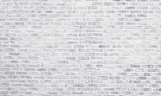 White washed brick wall texture. Light grey rough brickwork. Whitewashed vintage background