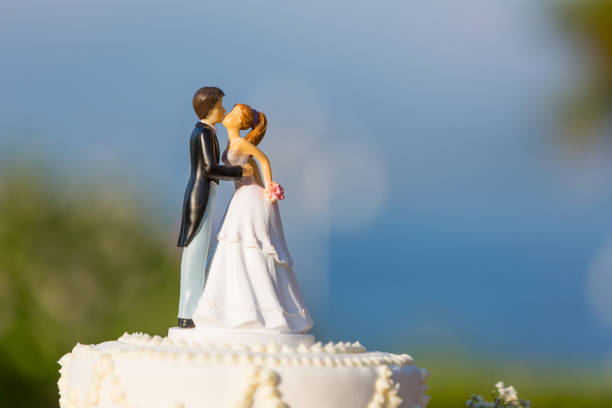white wedding cake with topper stock photo
