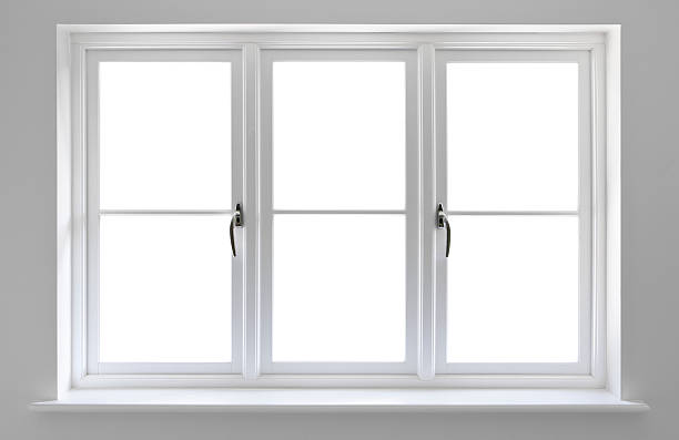 white windows very high quality manufactured wooden window frames with double glazed units set in a recess surrounded by a light grey wall.  window frame stock pictures, royalty-free photos & images