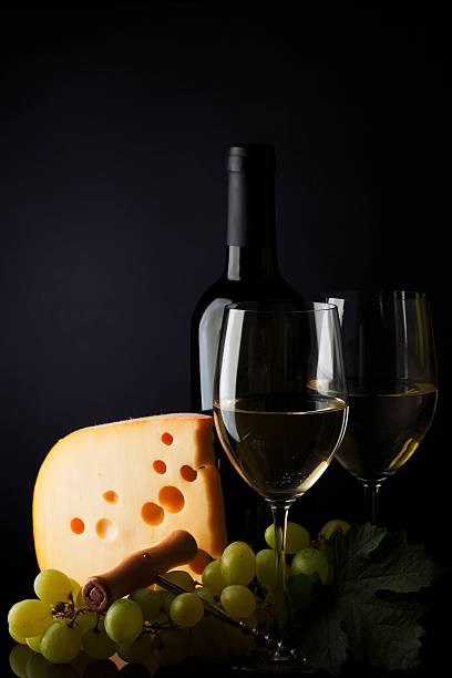 white wine and cheese on black