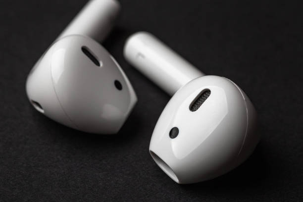 White wireless bluetooth earphones or headphones, close up stock photo