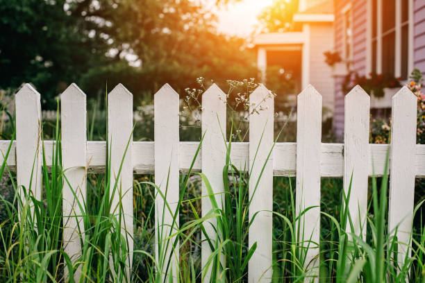 White wooden fence at detached house backyard White wooden fence in suburban neighborhood fence stock pictures, royalty-free photos & images