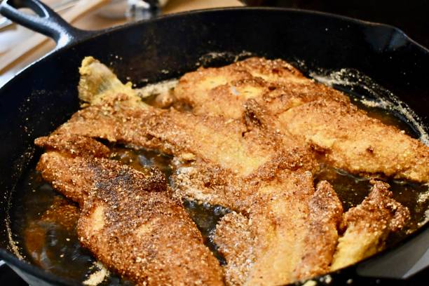 Whitefish with Cornmeal in a Cast Iron Frying Pan. stock photo