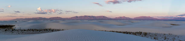 Whitesands Sunrise Panorama First rays of sun illuminates the mountain ranges in the background, at the beautiful White Sands National Monument erik trampe stock pictures, royalty-free photos & images