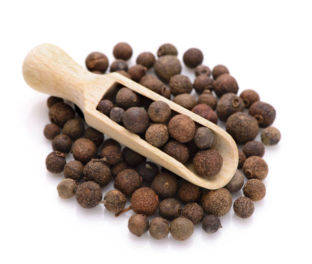 Whole allspice in a scoop stock photo