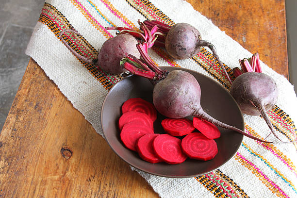 Whole and Sliced Beets on a Table stock photo