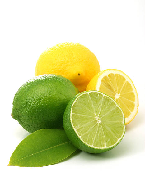Whole and sliced lemons and limes on a white background stock photo