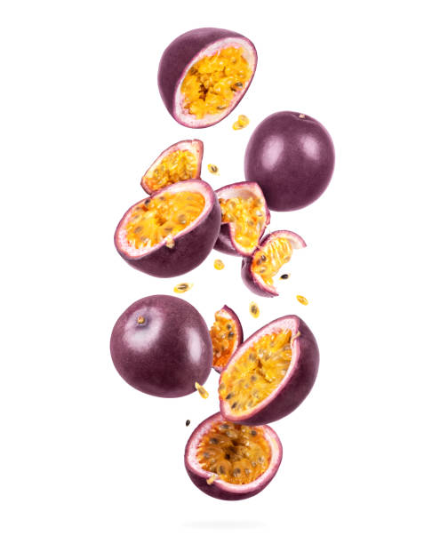 whole and sliced ripe passion fruit in the air, isolated on a white background - granadilla imagens e fotografias de stock