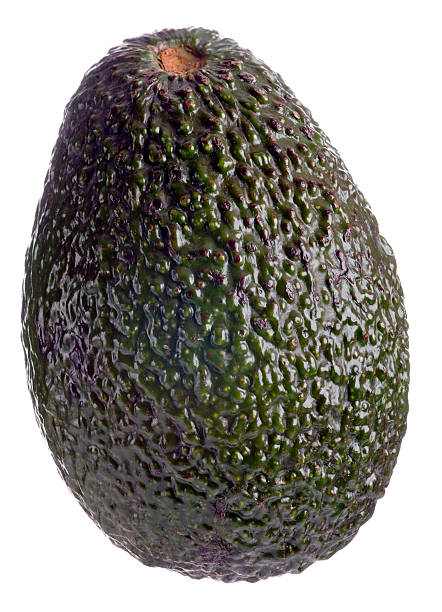 whole avocado on white background - avocado stockfoto's en -beelden