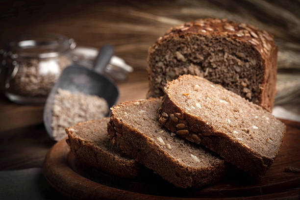 Wholemeal bread with sunflower seeds. Wholemeal bread with sunflower seeds. Dark light. 7 grain bread photos stock pictures, royalty-free photos & images