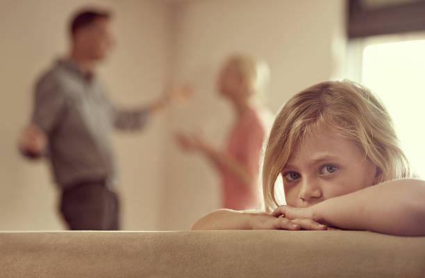Why do they have to fight? Shot of a little girl looking unhappy as her parents argue in the backgroundhttp://195.154.178.81/DATA/i_collage/pi/shoots/783299.jpg divorce stock pictures, royalty-free photos & images