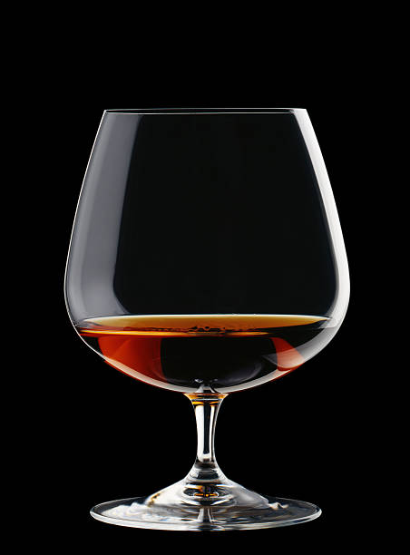 A wide glass of brandy isolated on a black background Brandy glass for Cognac, Brandy, Single Malt Whiskey on the black background brandy stock pictures, royalty-free photos & images