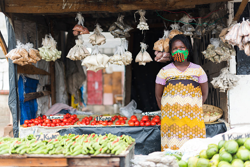 Wide shot portrait African woman working in market store