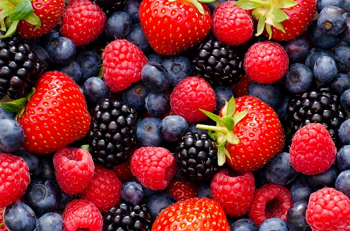 Close up / Macro photography of wild berry mix - strawberries, blueberries, blackberries and raspberries