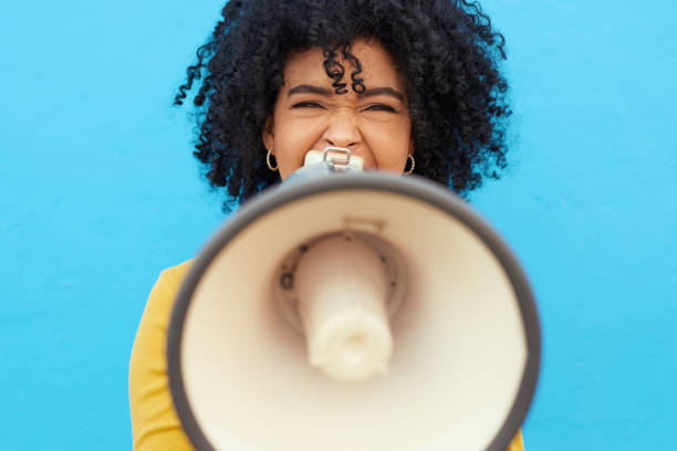 I will share what's on my mind! Cropped shot of a young woman holding a mega phone while posing against a blue background megaphone stock pictures, royalty-free photos & images