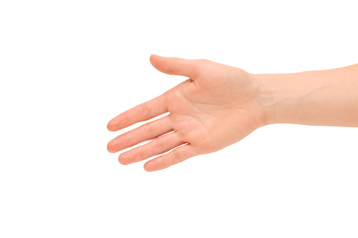 Hand of a young woman symbolizes the willingness to shake hands with everyone, studio shot isolated against a white background