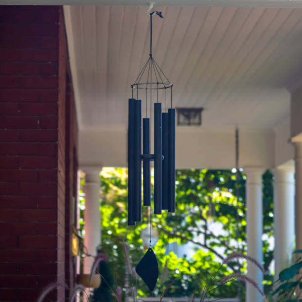 Wind chime on a red brick house with white pillars stock photo