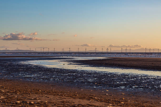 A wind farm off the Merseyside coast, at sunset stock photo