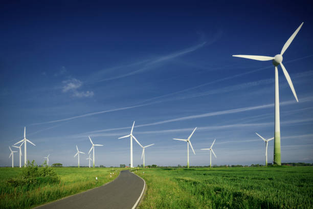 wind farm, straße, grüne wiese, klaren blauen himmel - neuauflage 2018 - sustainable future road stock-fotos und bilder