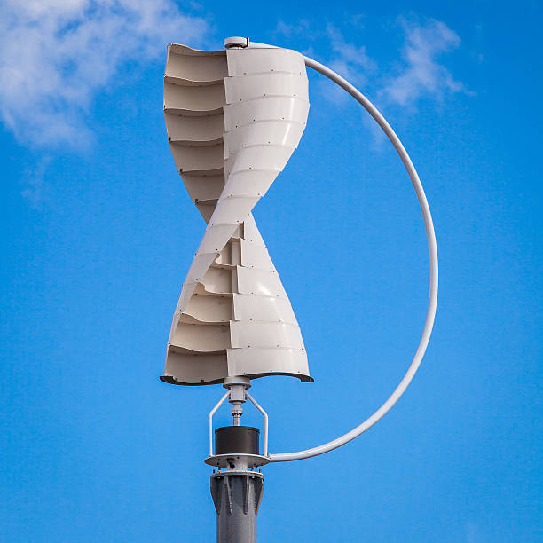 Wind Turbine Wind turbine in the vertical shape against blue sky background vertical axis wind turbine stock pictures, royalty-free photos & images