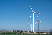 istock Wind turbine under blue sky 1399590128