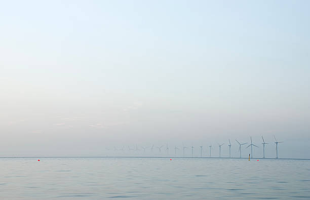 Wind turbines almost disappeared in the mist stock photo