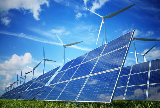 Wind turbines and solar plates making green energy stock photo